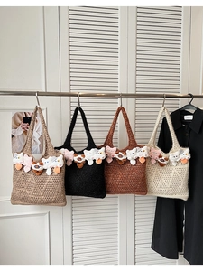 Detail of knitted hollow tote bags with cute 3D cat plush charms in multiple colors