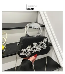 Detail of black rhinestone clutch with luxury silver handle and sparkling floral patterns