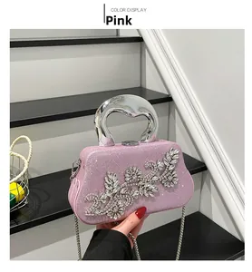 Pink glitter evening bag with crystal floral motifs and elegant silver metal handle
