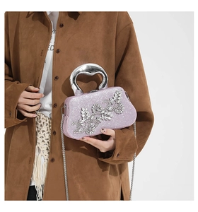 Detail of pink sequin evening bag with crystal flower and silver U-shaped metal handle