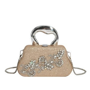 Detail of evening bag showing floral rhinestone patterns and sparkly sequin texture