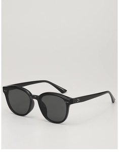 Detail of vintage black round sunglasses with decorative silver studs on the side temple