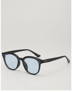 Close-up of black acetate frames with light blue lenses and silver triple dot rivets