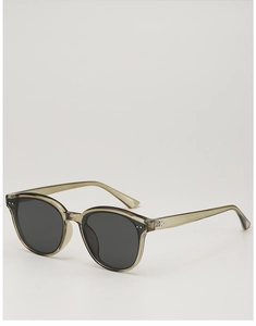 Detailed close-up of translucent olive green acetate sunglasses with silver rivet accents
