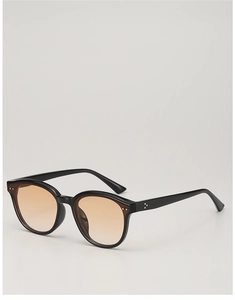 Detail of black frame sunglasses with orange gradient lenses and metal dots