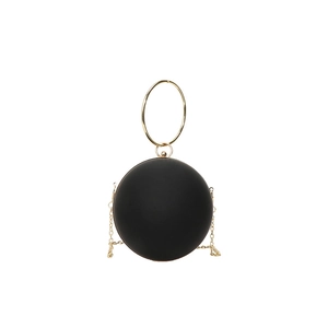 Minimalist black spherical evening bag with golden circular handle and chain strap