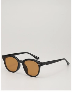Detail of vintage black sunglasses with amber lenses and silver triple dot rivets