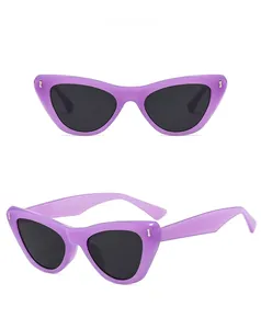 Cat eye sunglasses detail with jelly purple frames and grey lenses from two angles