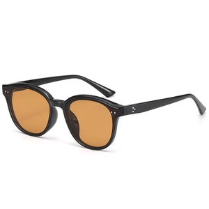 Retro black frame sunglasses with orange translucent lenses and silver rivet accents