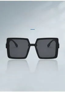 Detail view of square oversized sunglasses with gold G logo on the temple and black lens