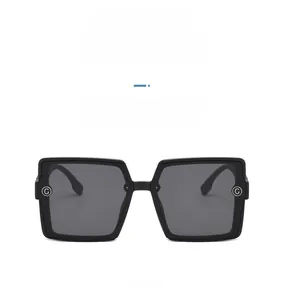 Front view of matte sand black square sunglasses featuring a metallic G logo on the temple
