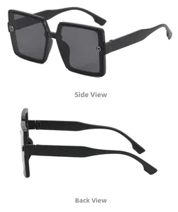 Detail view of large square black sunglasses featuring a silver G-logo on the side temple