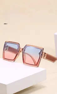 Detailed view of square sunglasses featuring gradient blue to pink lenses and tea frames