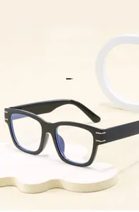 Close-up of black rectangular eyewear frames with silver hinge and blue light lenses