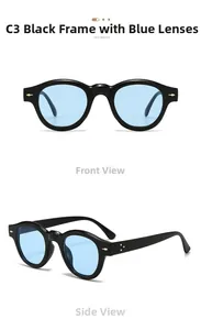 Detail view of round retro black sunglasses with blue lenses and gold arrow rivets