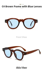 Detail view of round tea orange frames with light blue lenses and gold arrow hinges