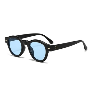Retro round black sunglasses with light blue lenses and gold rivet accents on white background