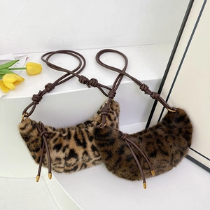 Chic faux fur leopard print crescent bag with leather knotted shoulder strap and gold accents