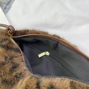 Plush leopard print faux fur shoulder bag with black lining and gold interior zipper detail