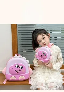 Pink EVA hardshell cartoon dinosaur backpack for toddlers shown in a cozy indoor setting