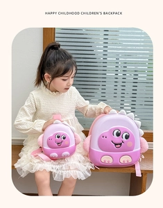 Pink EVA dinosaur eggshell backpacks in two sizes worn by a child in a sunny setting