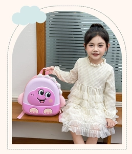 Pink and purple 3D dinosaur hardshell backpack for kids shown on a girl