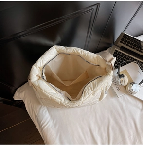 Internal view of off-white quilted puffer tote bag with spacious compartment and lining