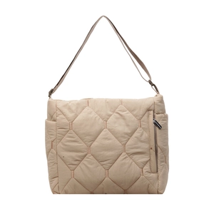 Close-up of beige quilted nylon shoulder bag showing hexagonal stitching and side zipper