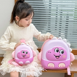 Pink EVA dinosaur shell backpack for kids in two sizes shown with child model on a bench