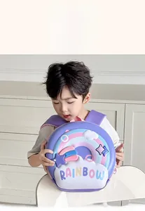 Toddler model wearing a purple EVA hard shell backpack with 3D rainbow and cloud patterns