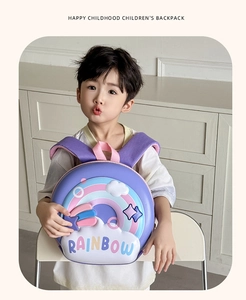 Kid's purple EVA hardshell backpack with 3D rainbow pattern worn by a small model