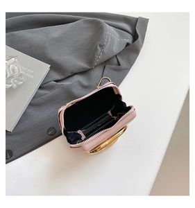 Top view of pink mini clutch showing black lining and gold circular metal handle