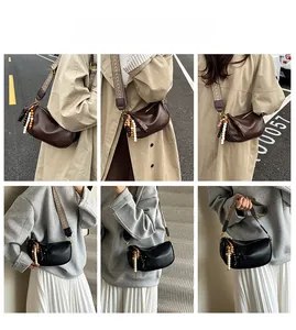 Street style display of retro crescent crossbody bag with wide jacquard strap and beads