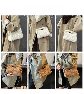 Detail of hand-knitted cable knit tote bag with hollow handle and slim metal chain strap
