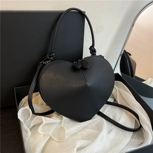 Elegant black heart-shaped handbag with adjustable shoulder strap and smooth finish