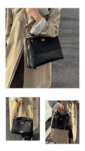 Detail of black quilted leather tote with gold chain strap and turn-lock closure