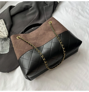 Detail of two-tone quilted tote bag featuring brown suede and black leather texture