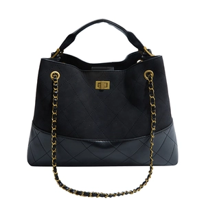 Classic quilted black suede and leather handbag with gold chain strap on white background