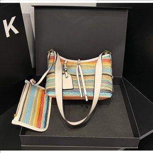 Detailed close-up of a rainbow woven crossbody bag with a matching small zipper pouch