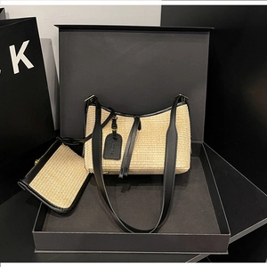 Detail of straw woven bag set with black leather trim and small zipper coin pouch
