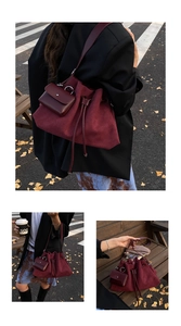 Detail of wine red matte leather bucket bag with drawstring and mini matching pouch