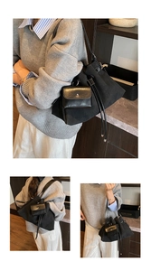Detail of black canvas bucket bag with matching leather coin purse and drawstring closure