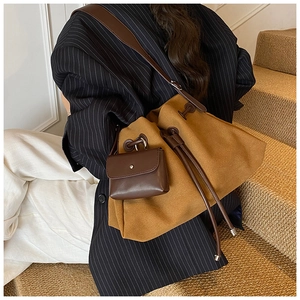 Detailed view of brown matte suede bucket bag with drawstring and matching coin pouch