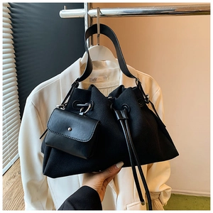 Detail of minimalist black bucket bag with drawstring and detachable coin purse