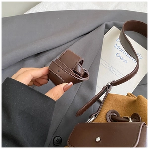 Close-up of brown leather strap with neat stitching and silver metal hardware details