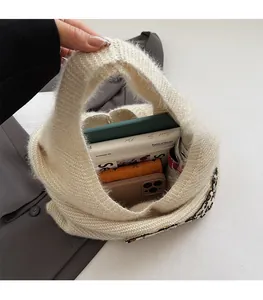 Detailed interior of the beige knitted tote bag showing its large storage capacity