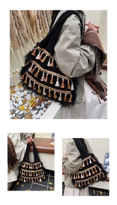 Close-up of bohemian black knit tote bag featuring colorful tassels and wide shoulder strap