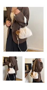 Detail of white plush bucket bag featuring soft handle and cute leopard bow bear charm
