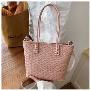 Detail of pink woven leather texture and metal buckle on this large tote bag