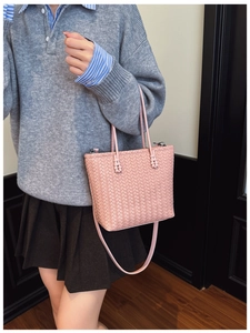 Close-up of pink woven tote bag showing detailed texture and silver metal hardware